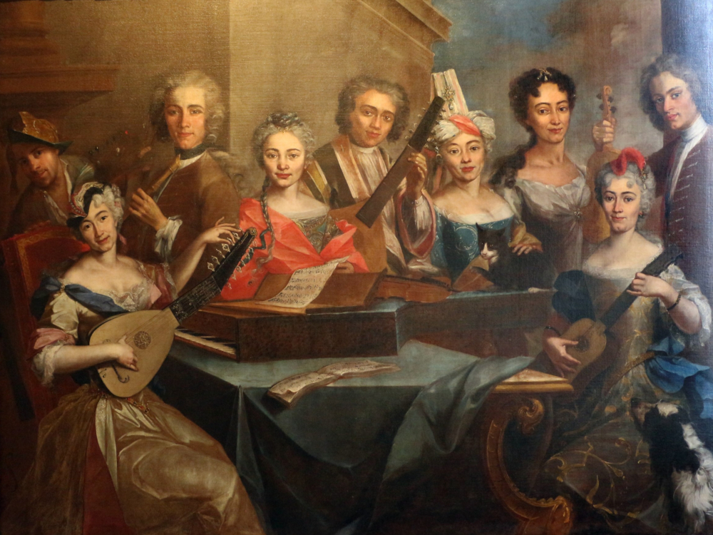 An Italian musical family from the 1760s showing 5 women and 4 men standing around a small keyboard instrument on a table.  They are all holding their instruments, which include a guitar, lute, theorbo, and violins. 