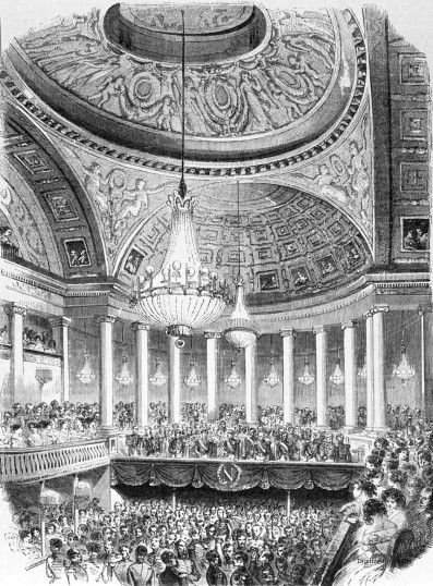 Sketch of a concert in the theatre of the Tuileries palace in Paris in the mid-19th century.  There are two levels of crowded seats, a main floor and a wrap-around balcony, with a high ceiling supported by columns.  The ceiling is domed and covered with elaborate artwork, and a massive chandelier hangs over the center of the room.